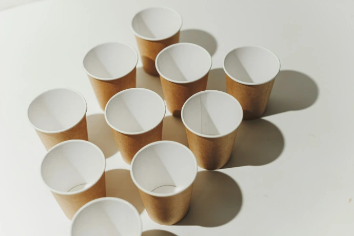Several empty paper cups arranged on a white surface